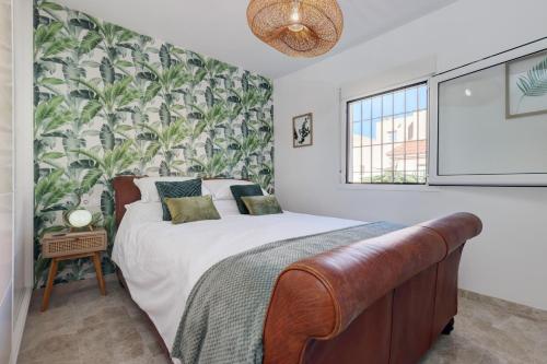 a bedroom with a bed and a plant wall at Luxury modern beachfront 3 bed gated community townhouse with pool, sun terrace, sea views close to all amenities in Manilva