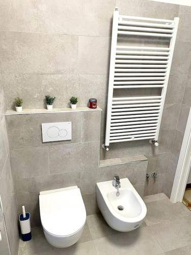 a bathroom with a white toilet and a sink at Casa Vacanze Ca' di Lucchini in San Benedetto Val di Sambro