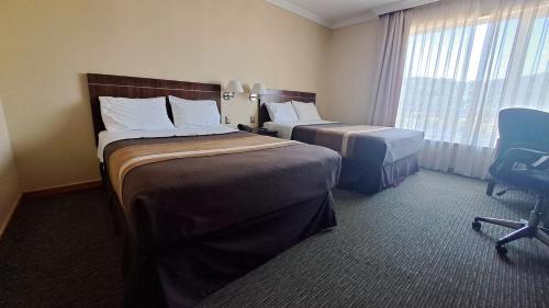 Una cama o camas en una habitación de Hotel Diego de Almagro Temuco