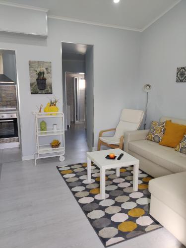 a living room with a couch and a coffee table at Riviera Beach B in Praia da Vitória