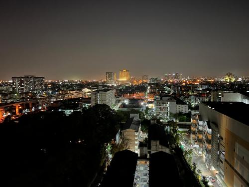 a view of a city at night with lights at Mall Suites Hotel in Bangkok