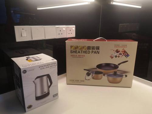 two boxes sitting on a counter next to aether heated pan at Millerz Square全新房源@Old Klang Road 1909 in Kuala Lumpur