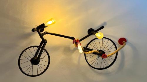 a toy bike with a rope hanging on a wall at Casa Casco Historico in Frigiliana