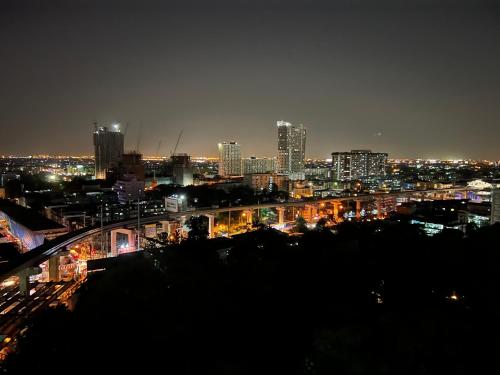 a view of a city at night with lights at Mall Suites Hotel in Bangkok