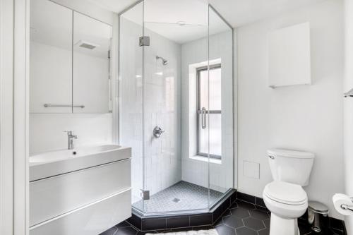 a bathroom with a shower and a toilet and a sink at Downtown BK 2BR w Terrace WD nr Barclays NYC-658 in Brooklyn