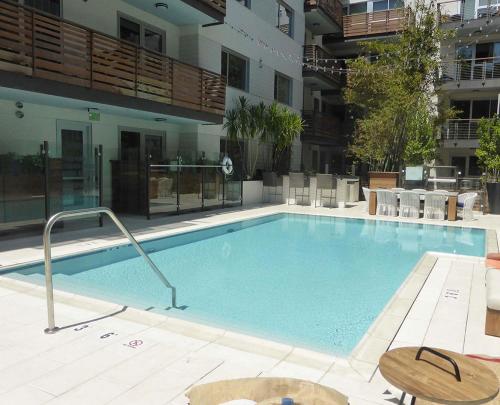 a large swimming pool in the middle of a building at Masterpiece 2-Bedroom with Balcony, Pool, and Spa in Los Angeles