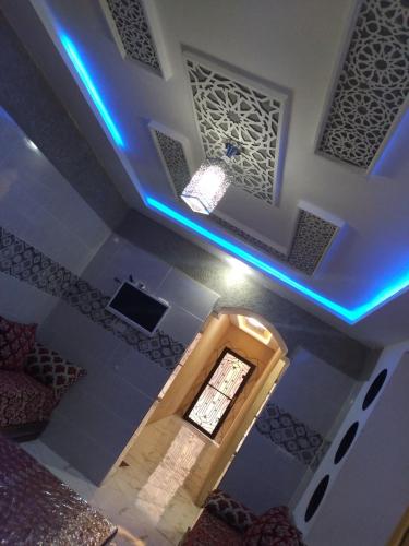 a room with a ceiling with blue lights and a window at Appartement a louer MASSINI in Tiznit