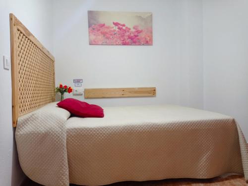 a bed in a white room with at Hostal Buena Vista in Vejer de la Frontera