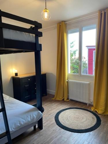 a bedroom with a bunk bed and a window at Maison rouge in Millau