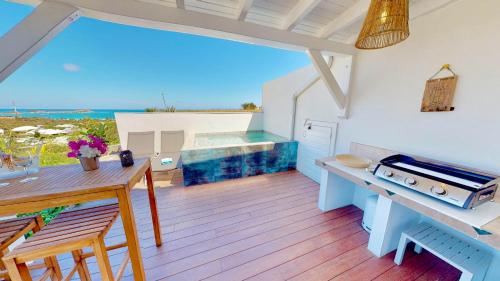 a kitchen with a table and a view of the ocean at SUNSEEKER SXM - Luxury Guest House 4 stars - Amazing Sea View Pinel - Tintamarre in Orient Bay