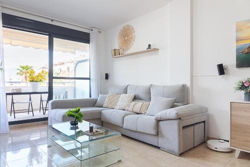 a living room with a couch and a glass table at Salinas Mar y Playa in Roquetas de Mar
