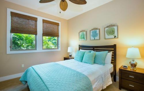 a bedroom with a bed and a ceiling fan at Mauna Lani Kamilo Home 424 in Waikoloa