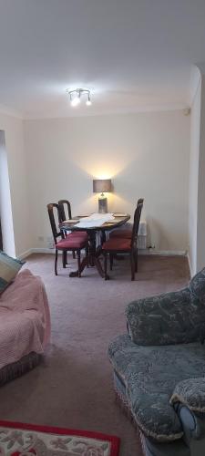 a living room with a table and chairs at The Bungalow in Longdendale