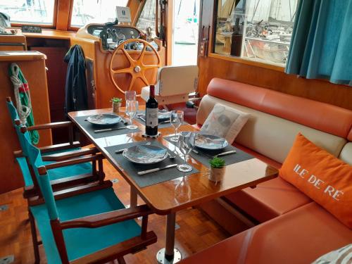 a table with a bottle of wine on a boat at Bateau Atypique Yacht La Rochelle in La Rochelle