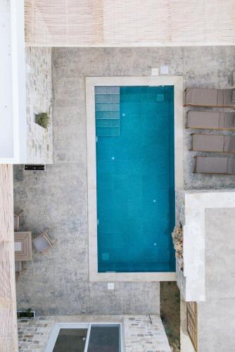 a swimming pool in a house with a blue water at Villa Pagona in Pitsidia