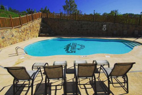 a group of chairs sitting in front of a swimming pool at A Shining Starr Beautiful MTN Views Hot Tub in Sevierville