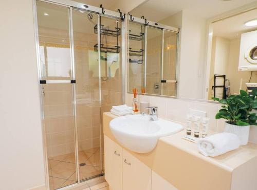 a bathroom with a sink and a shower at Waterfront Apt Maroochy River in Maroochydore