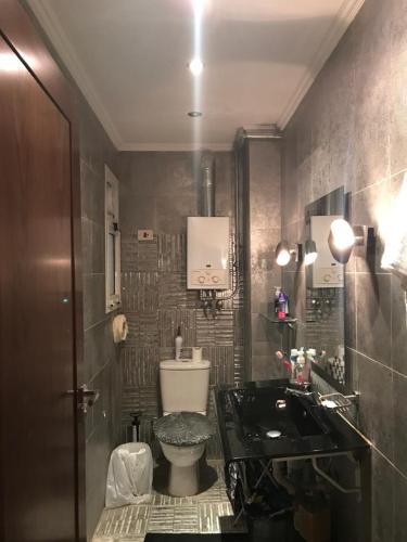 a bathroom with a toilet and a sink at مدينتي in Cairo