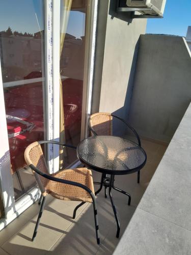 a table and two chairs on a balcony at Perper in Sutomore