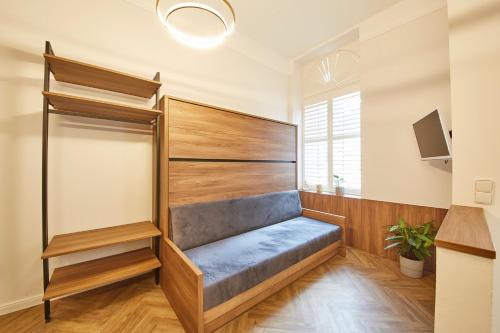 a dressing room with a bench and a tv at Nove Boutique Apartments in Vienna