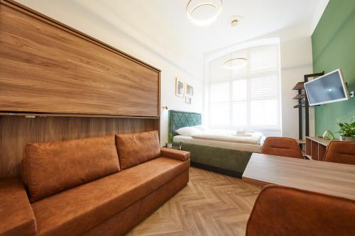 a living room with a couch and a bed at Nove Boutique Apartments in Vienna