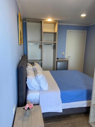 a bedroom with a large bed and a table at Persephone in Himare