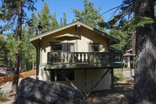 a small house with a deck with an umbrella at 3407 Pine Hill Home in South Lake Tahoe