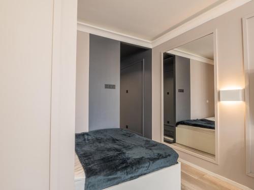 a bedroom with a bed and a mirror at Enes Apartments Softy Lofty 2 in Wrocław