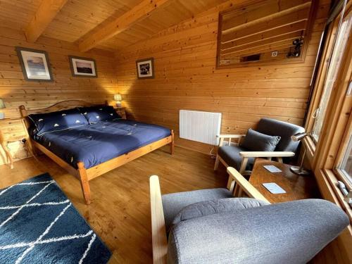 a bedroom with a bed and a couch and a chair at The Bee Hive Garden Room in Dorchester