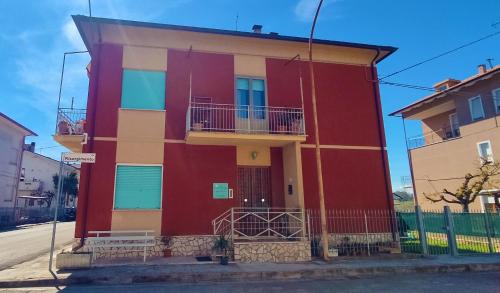 a red building on the side of a street at Casa Elvezia Guest House in SantʼElpidio a Mare