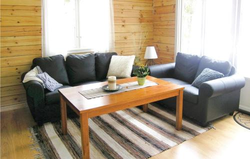 a living room with a couch and a coffee table at 3 Bedroom Awesome Home In Sävsjö in Gistingstorp
