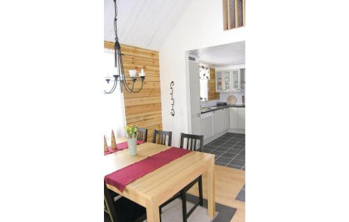 a kitchen and dining room with a wooden table at 3 Bedroom Awesome Home In Sävsjö in Gistingstorp