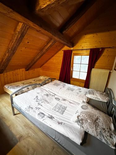 ein Schlafzimmer mit einem großen Bett im Dachgeschoss in der Unterkunft Swiss Lake Mountains Apartments in Därligen