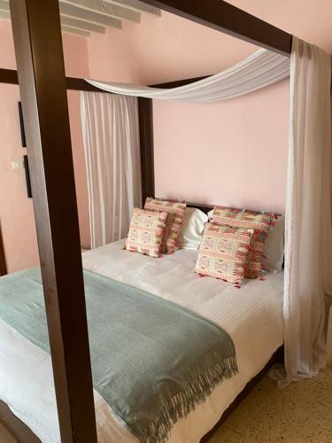 a bedroom with a bunk bed with a canopy at Dar Camelia in Soûr