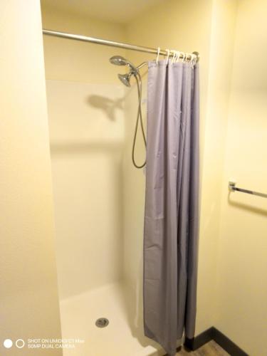 a shower with a purple shower curtain in a bathroom at Private Room North Portland in Portland