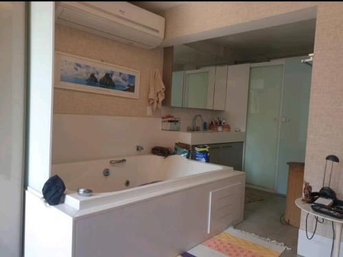 un bagno con una grande vasca bianca in una cucina di Apartamento Luxuoso Frente Mar e MAC a Niterói