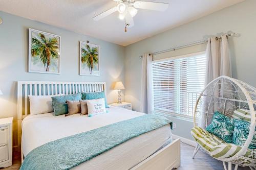 a bedroom with a white bed and a window at Shores of Panama 2310 in Panama City Beach