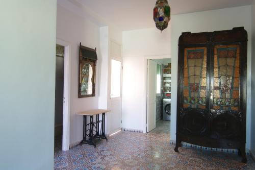 a hallway with a door with stained glass at zina surf house in Oualidia