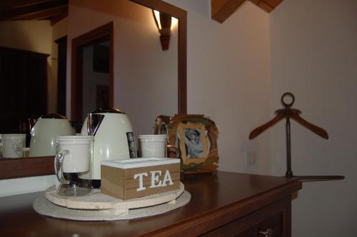 a table with a tea kettle and cups on it at Narciso B&B Valbrona in Valbrona