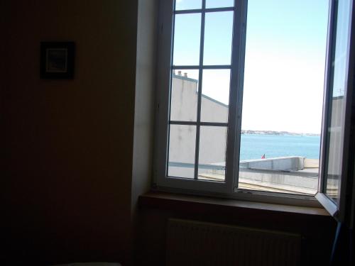 a window in a room with a view of the ocean at Hôtel San Pedro in Saint Malo