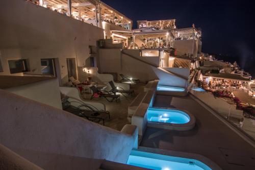 a view of a rooftop pool at night at On the Cliff in Fira