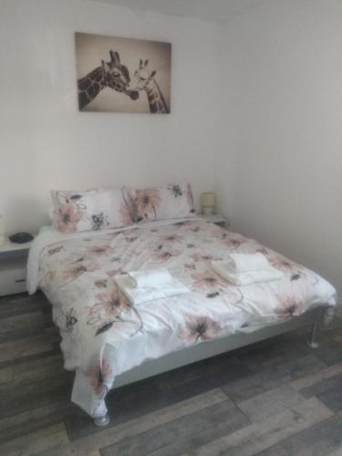 Un dormitorio con una cama con flores. en Cheltenham - 3 Bed Newly Renovated With Parking en Cheltenham