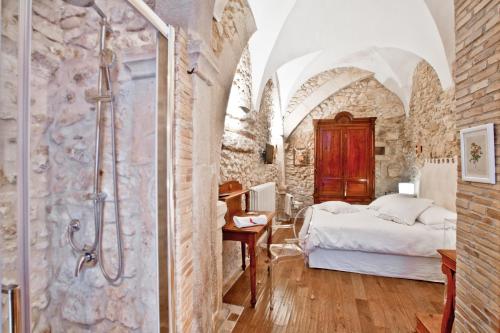 a bedroom with a shower and a bed in a room at B&B Il Marchese Del Grillo in Sulmona