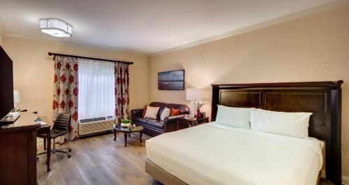 a hotel room with a bed and a chair at Ayres Hotel Costa Mesa Newport Beach in Costa Mesa