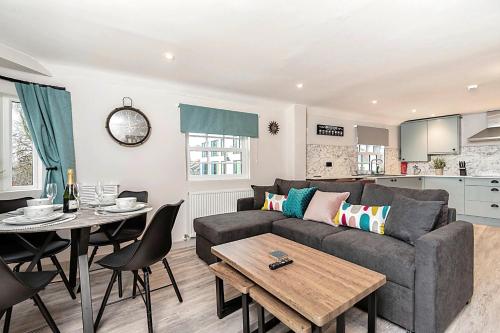 a living room with a couch and a table at The Burton Penthouse by Fortuna Property Portfolio in Cheltenham