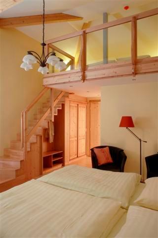 a bedroom with a bunk bed and a staircase at Hotel Belle Vue in Vianden