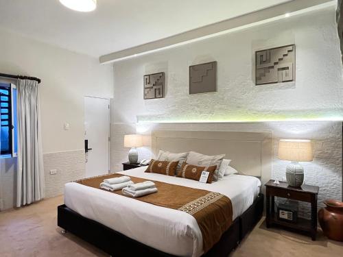 a bedroom with a large bed with towels on it at Katari at Plaza de Armas Cusco in Cusco