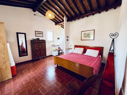 a bedroom with a bed with a red comforter at La Collina sul Mare in Campo nell'Elba