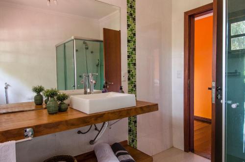 a bathroom with a sink and a mirror at Refúgio com piscina e churrasqueira in Sao Paulo