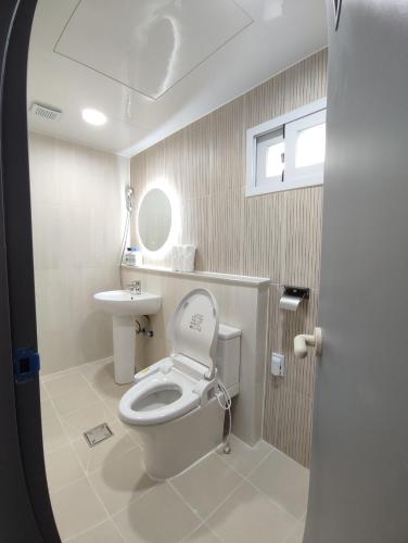 a bathroom with a toilet and a sink at Aha Stay in Gyeongju